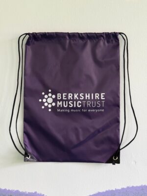 Purple drawstring bag featuring white Berkshire Music Trust logo